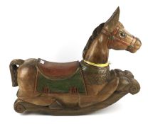 A modern heavily carved hardwood recumbent rocking horse.