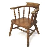 An early 20th century smokers bow chair with turned spindles.