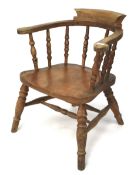 An early 20th century smokers bow chair with turned spindles.