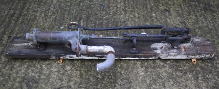 A vintage water pump mounted on a wooden wall bracket L158cm.