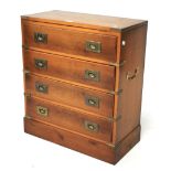 A yew wood campaign style chest of four drawers.