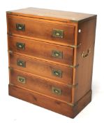 A yew wood campaign style chest of four drawers.