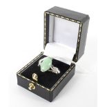 A Jade oval shaped dress ring stamped 18k 3.