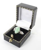 A Jade oval shaped dress ring stamped 18k 3.