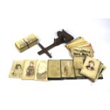 A Victorian stereoscopic viewer with a collection of early stereoviews and cabinet photographs.