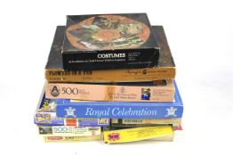 An assortment boxed jigsaw puzzles.