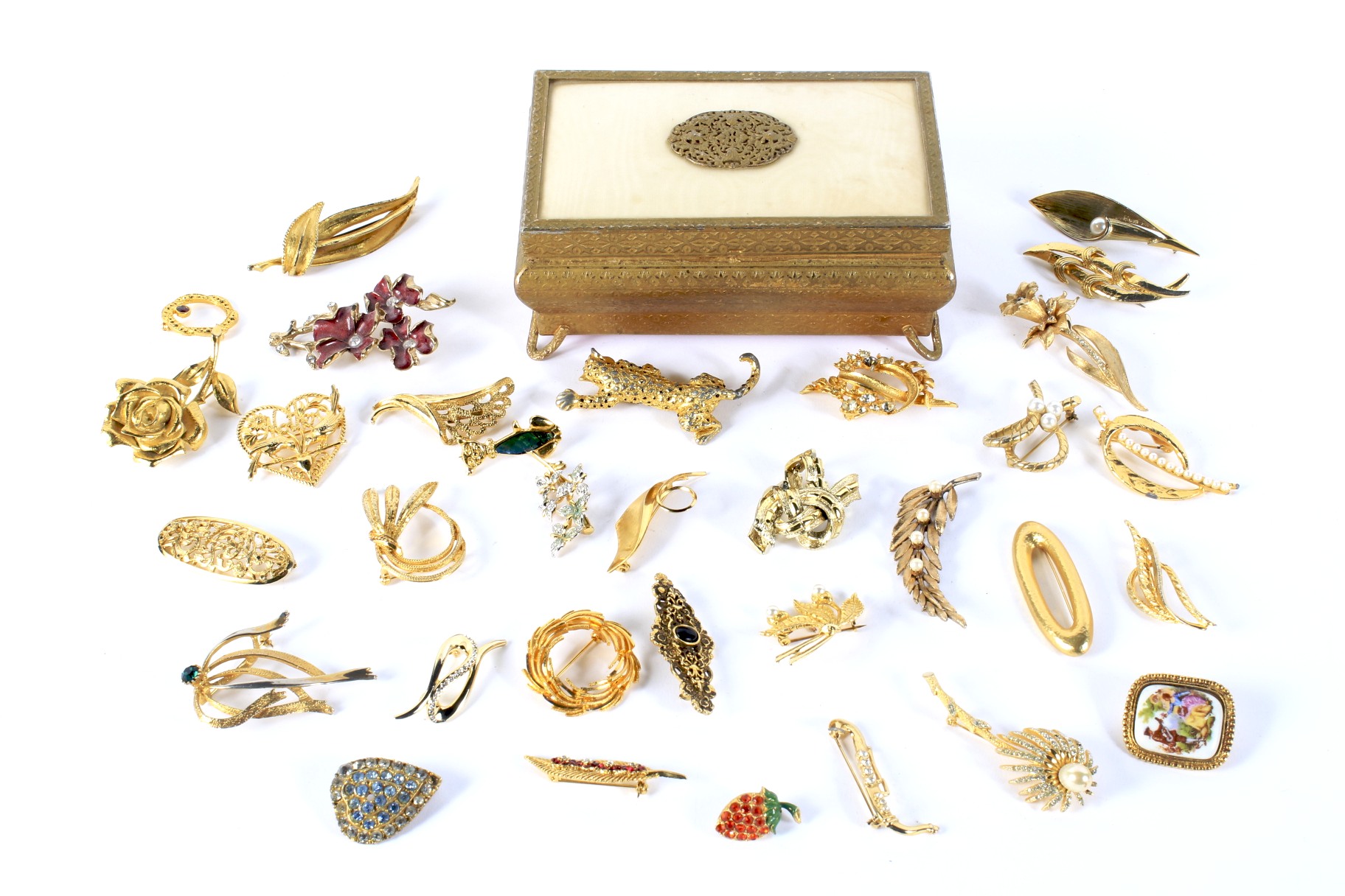 A collection of gilt metal brooches.