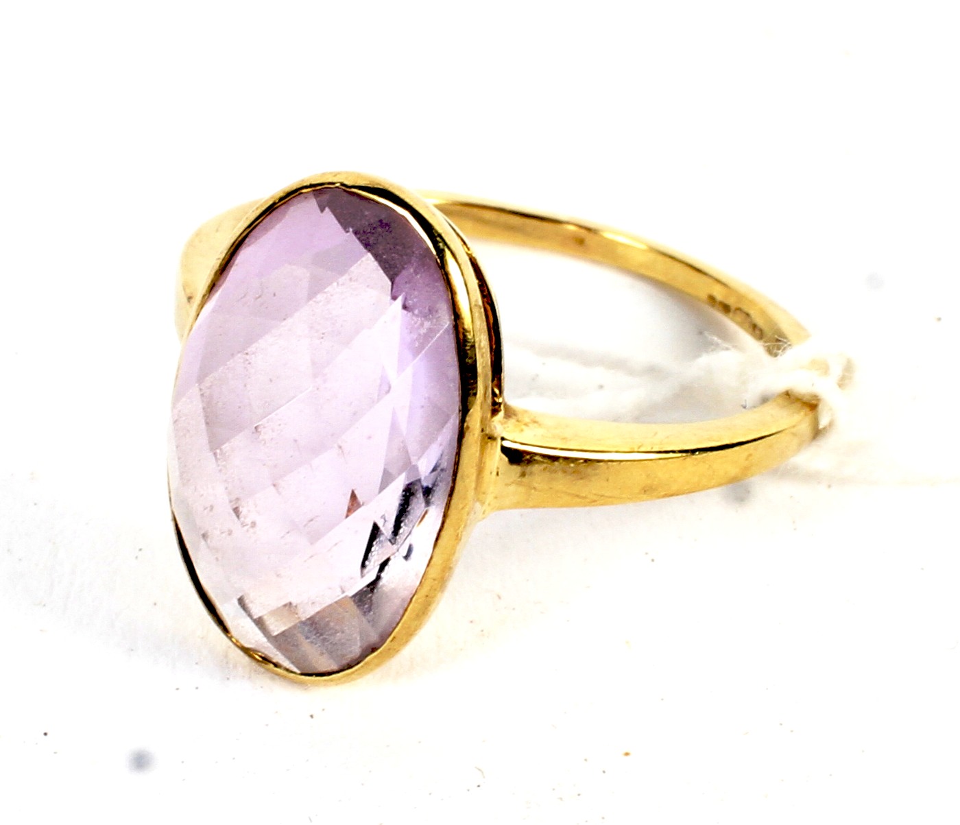 A 9ct gold ring set with a synthetic amethyst size P, 3.1 grams.