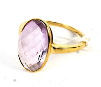 A 9ct gold ring set with a synthetic amethyst size P, 3.1 grams.