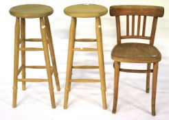 Two contemporary pine bar stools and a small wooden chair.