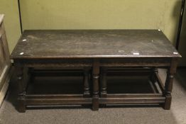 An 18th century style stained oak nest of three tables.