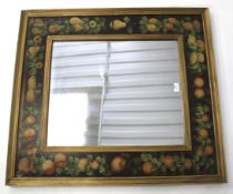 A decorative wall mirror the painted frame depicting fruit bordered with a gilt edge 82cm x 93cm.