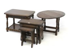 A nest of three oak tables a drop leaf table and coffee table with under tier