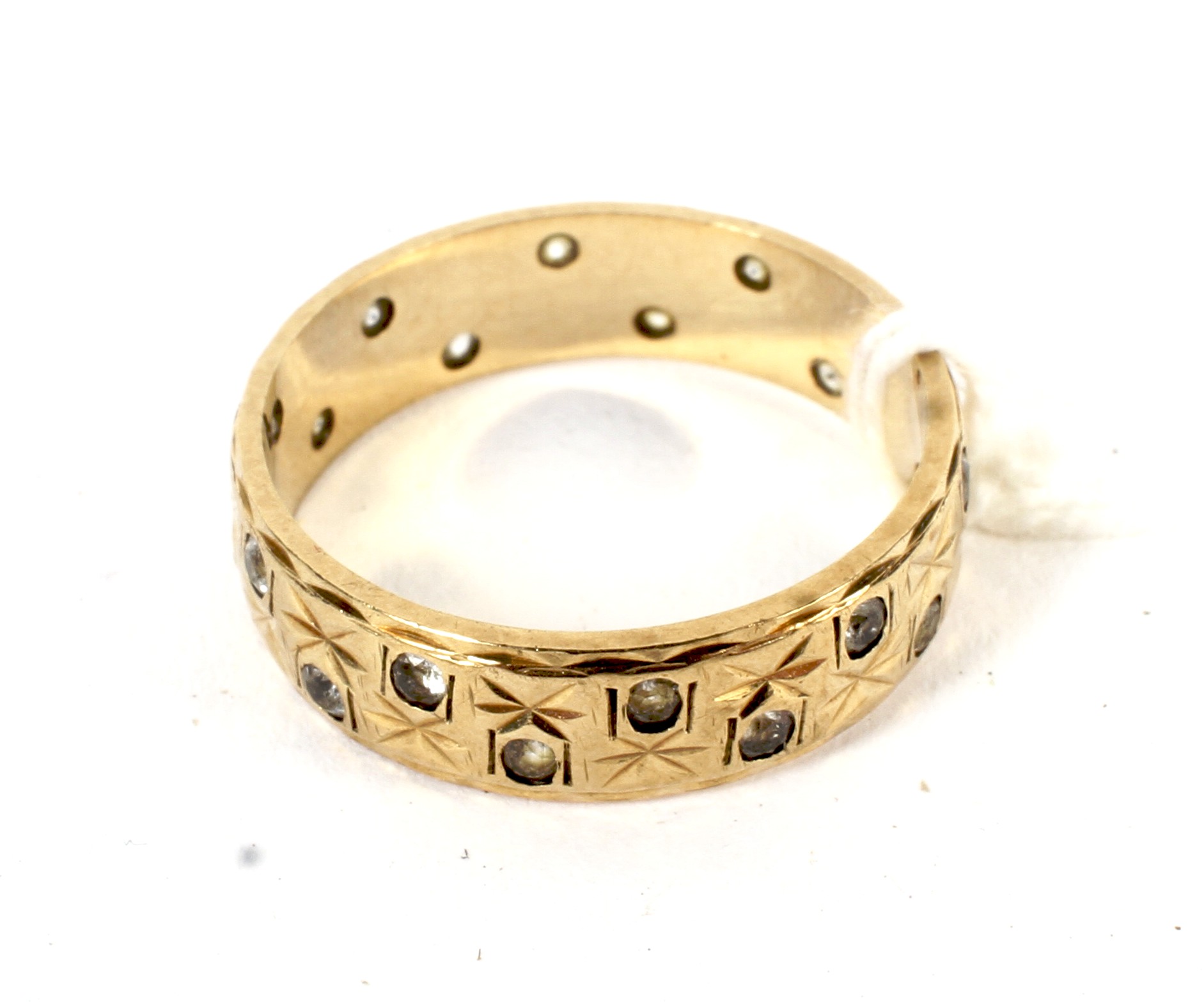 A 9ct gold band set with faux diamonds, size N, 2.9 grams.