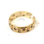 A 9ct gold band set with faux diamonds, size N, 2.9 grams.