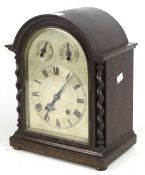 An oak cased dome topped 8 day mantle clock with barley twist columns,