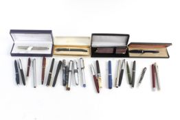 An assortment of fountain pens including Sheaffer and a Waterman.