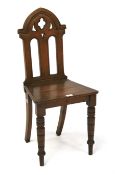 A small ecclesiastical oak chair.