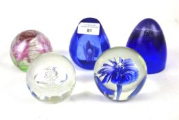 Five glass paperweights.