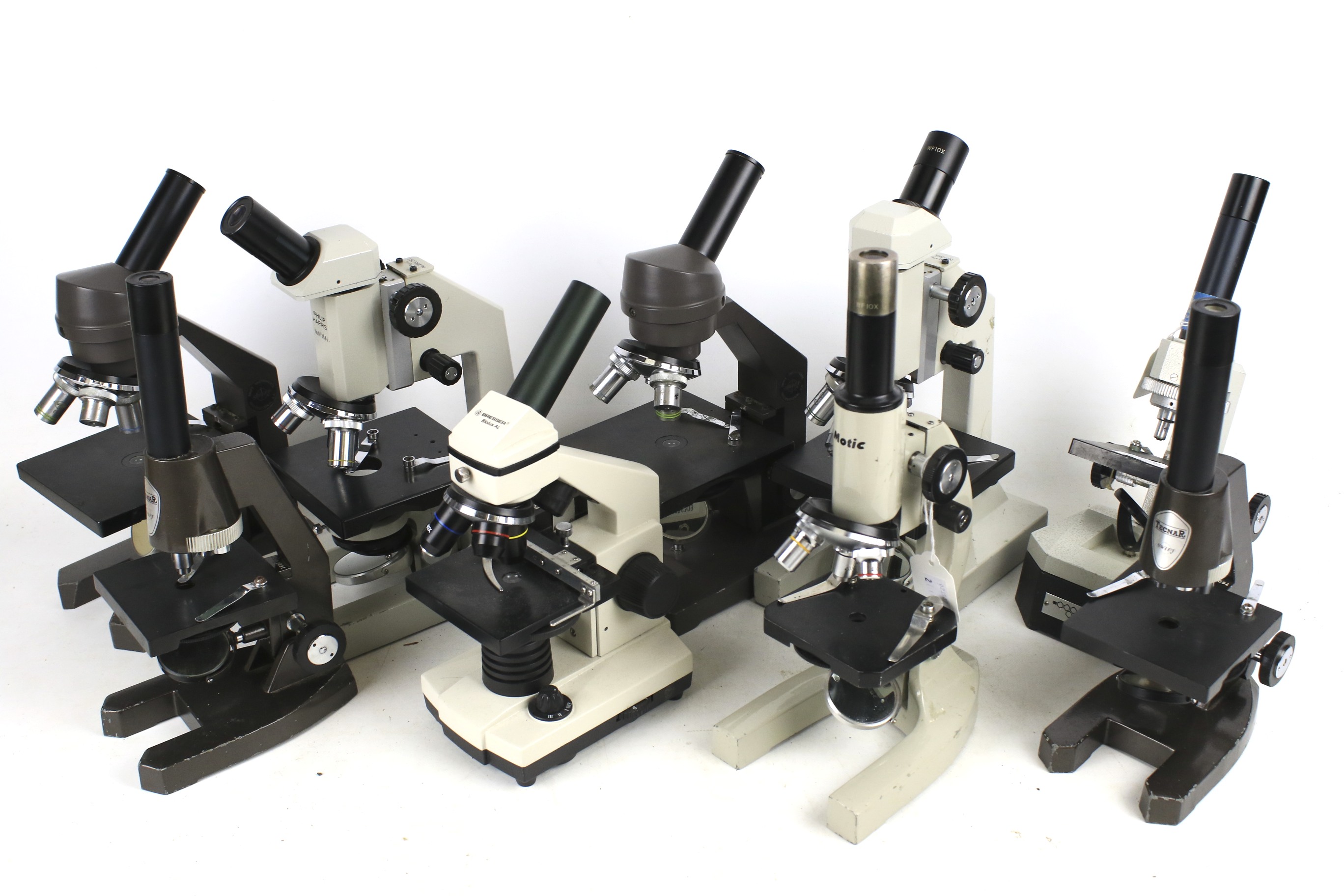 Nine assorted student microscopes includ
