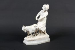An early 20th century alabaster model of a girl and goat on plinth base.