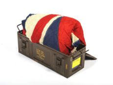 A military trunk with a large Ensign Naval St George and Union Jack flag.