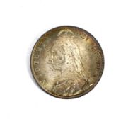 An 1888 half crown coin. Obverse with bag marks.