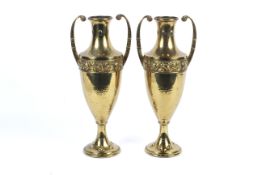 A pair of 20th century neo-classical style oviform two-handled gilt-metal vases.