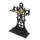 A Victorian Aesthetic Movement black painted cast iron and brass umbrella stand.