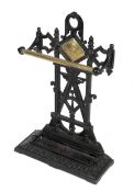 A Victorian Aesthetic Movement black painted cast iron and brass umbrella stand.