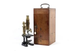 A brass mounted Carl Zeiss Jena microscope fitted in a wooden case.
