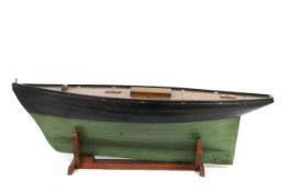 A large early 20th century pond yacht and stand.