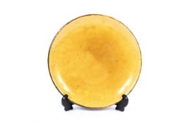A 20th century Continental mustard glazed pottery circular dish.
