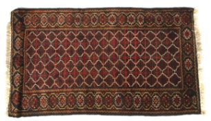 A 20th century wool rug woven with geometric patterns.