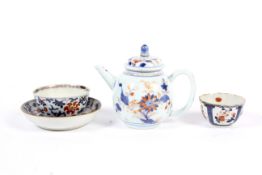 An 18th century Chinese imari teapot and cover, a teabowl and saucer and a similar teabowl.