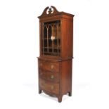 An Edwardian mahogany glazed small bookcase on chest.