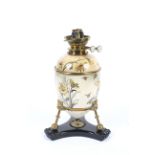 A late 19th century printed pottery and brass mounted oviform oil lamp.