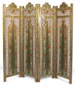 A 20th century Indian style painted and gilt fretwork four-panel folding screen.