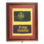 A framed and glazed WWII Fire Guards arm band and a Boy Scouts War Service Scouts arm band.