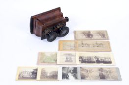 A Victorian burr walnut veneered stereoscopic viewfinder and related cards.