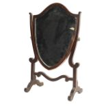 A Regency mahogany shield shaped dressing table mirror.