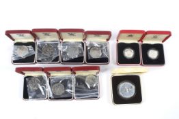 Three silver proof coins and seven boxed 1973 50p coins.