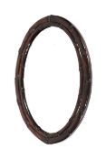 A 20th century Chinese hardwood 'bamboo' framed oval wall mirror.