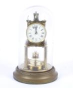 A 20th century Gustav Becker brass Anniversary torsion clock under a glass dome.