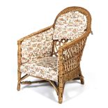 A bamboo and wicker framed conservatory chair with drop-in chinoiserie pattern cushions.