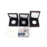 Three Royal Mint silver proof coins.