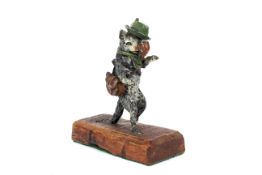 An early 20th century cold painted bronze figure of a cat in hunting clothes.