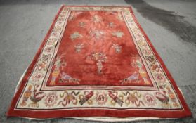 A large 20th century red ground Chinese carpet.