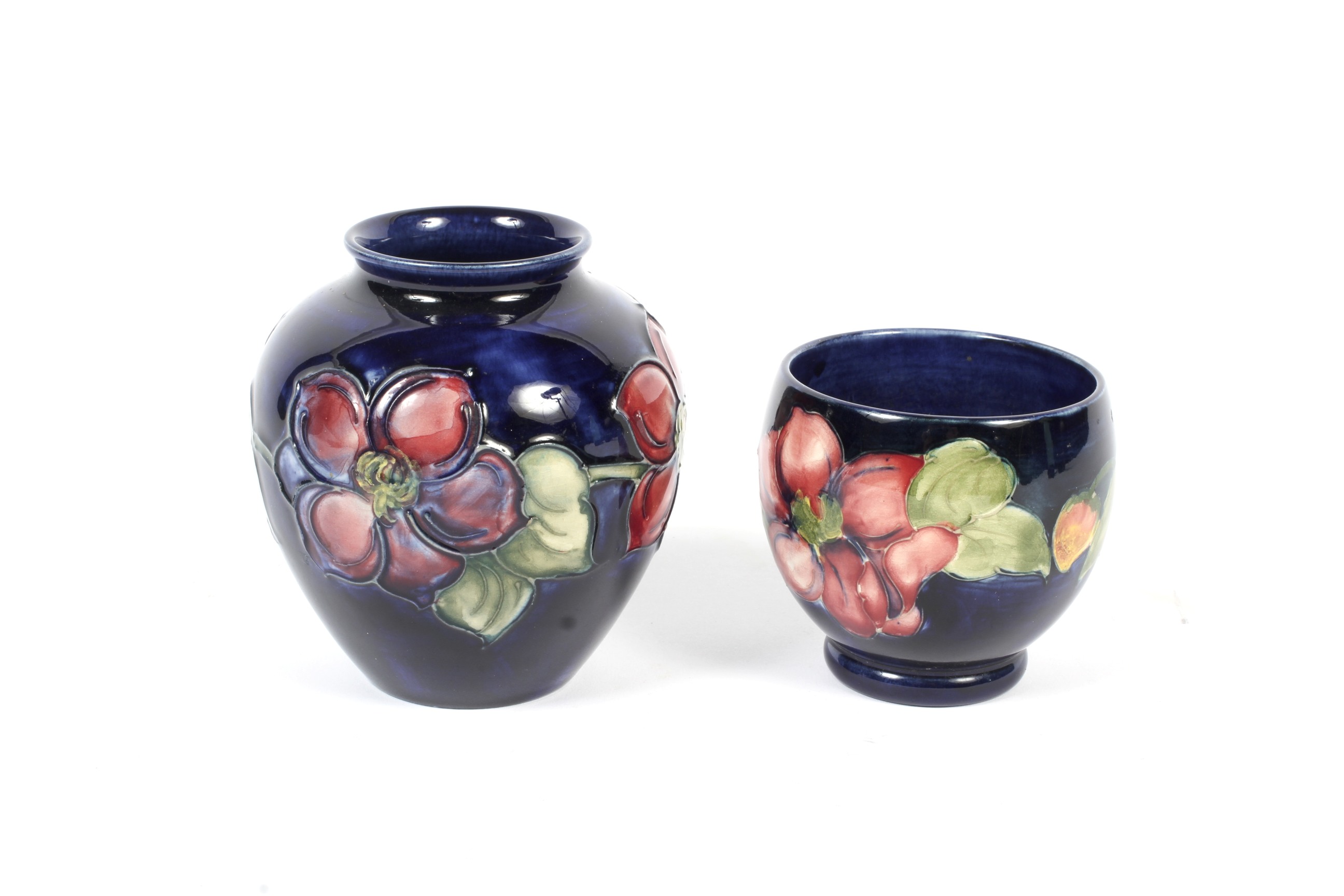 Two mid-20th century Moorcroft blue-ground Anemone pattern vases. Impressed marks,