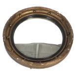 An Irish Georgian style 20th century circular giltwood convex wall mirror.